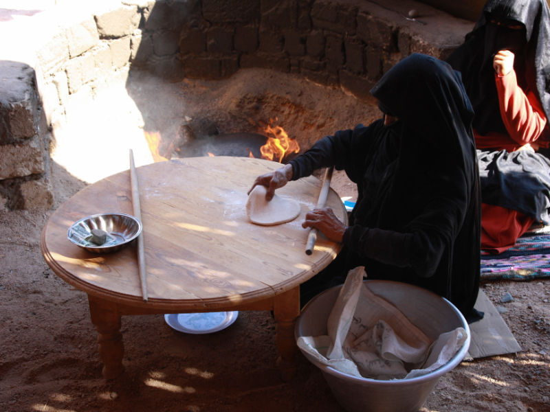 A Bedouin woman baking traditional bread